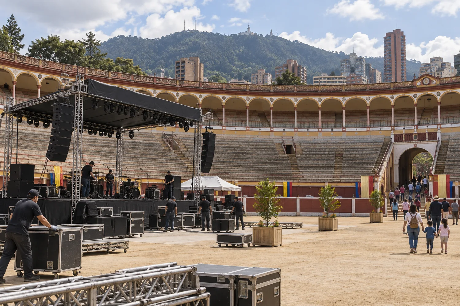Workers preparing a concert stage inside an empty Colombian-style bullring.